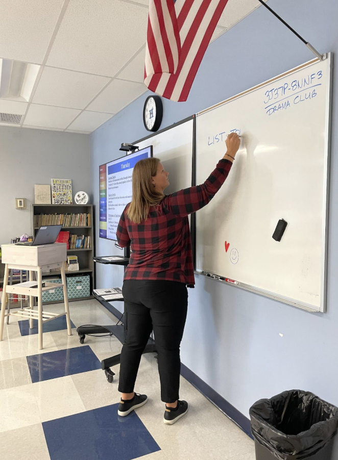 Mrs. LaNicca writes out instructions for her new students.
